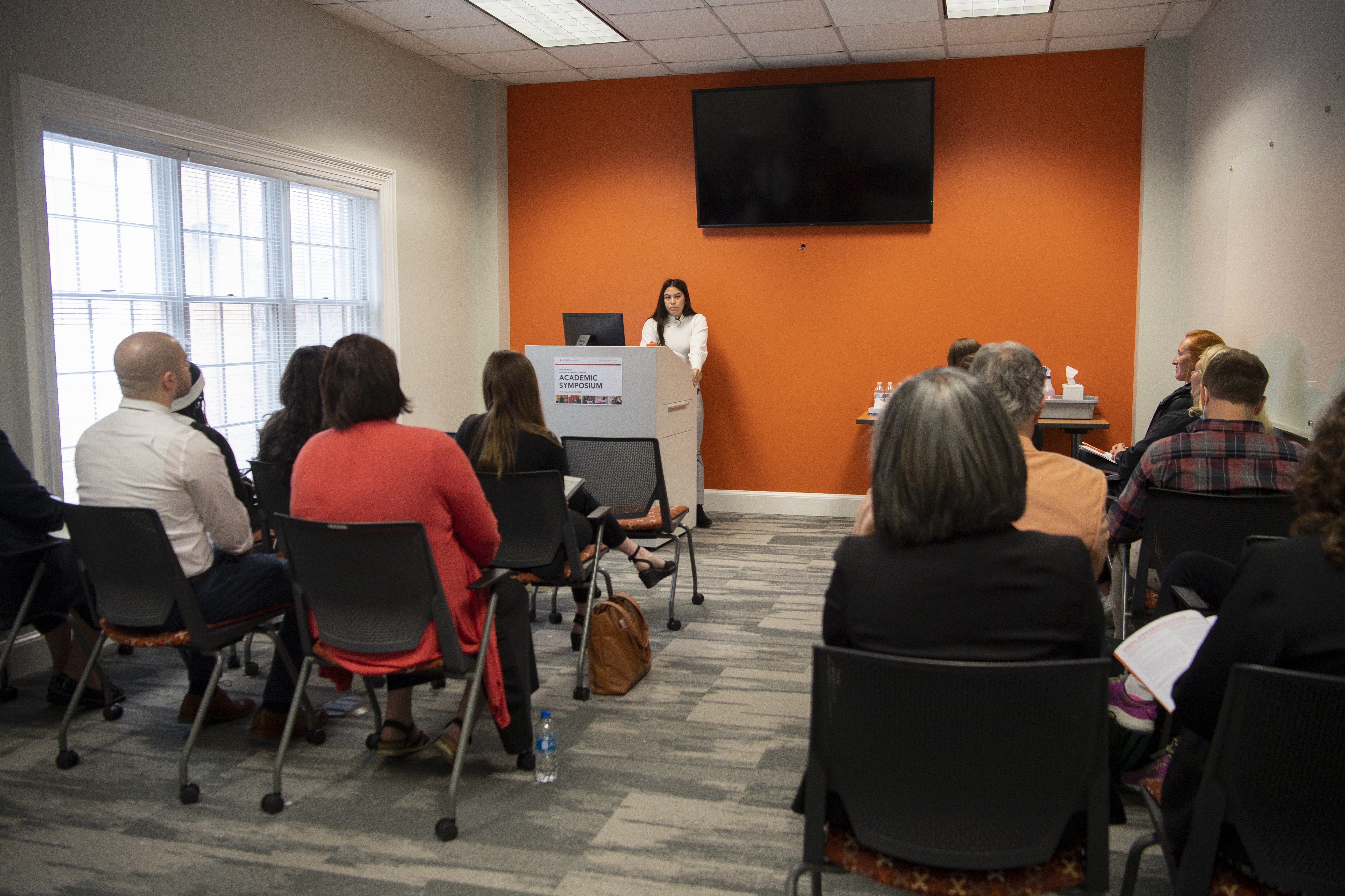 Student presents symposium talk to an audience